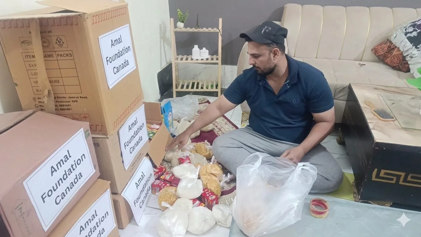 Volunteer preparing supplies beside boxes labelled Amal Foundation Canada